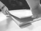 Placing plexiglass, mat, artwork, and backing into a wood picture frame