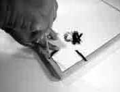 Screwing metal mounting brackets into the back of a wood picture frame