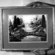 Completed wood picture frame with wire ready for hanging